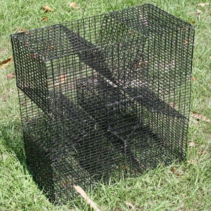 Pinfish Trap that is black sitting on a grassy lawn. 